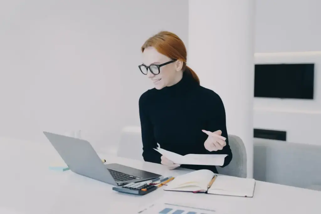 Businesswoman is making presentation for client online. Video call conference in office.