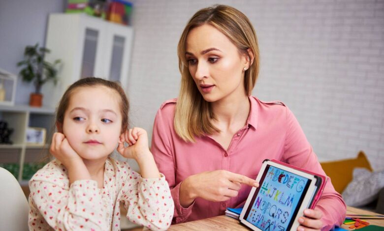 bored girl her mother studying with laptop home wp