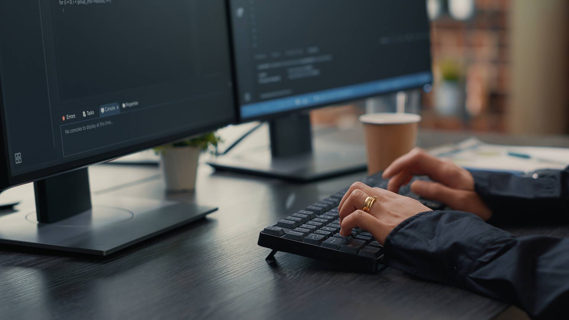 focus software developer hands typing source code keyboard while looking computer screens with programming interface programer sitting desk with clipboard writing algorithm wp